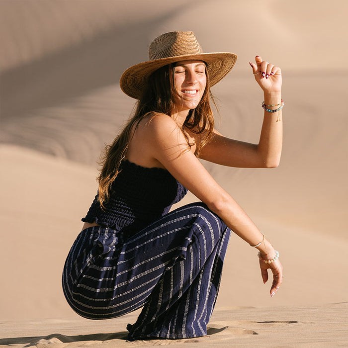 Navy Sailor Stripe Cotton Cabana Pants, worn crouched on dunes