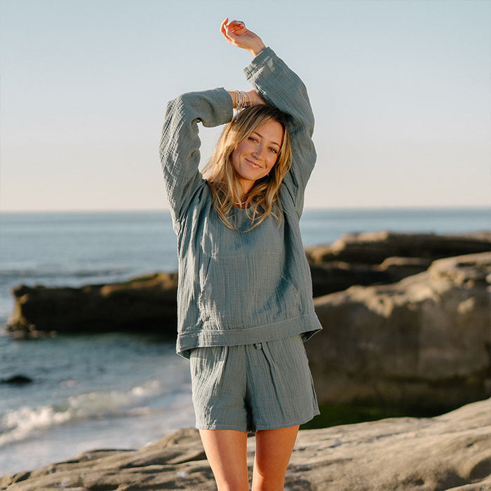 New Moon Blue Baja Pullover, worn with arms raised