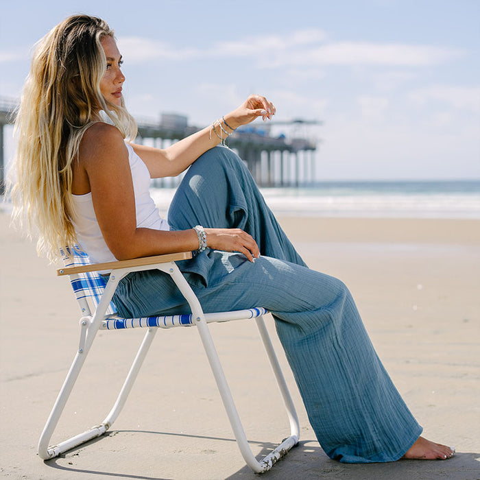 New Moon Blue Cabana Pants, worn seated on beach