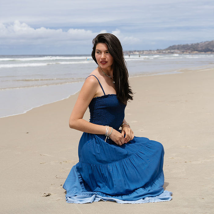 Ocean Mist Mai Tai Maxi Dress, seated on the beach
