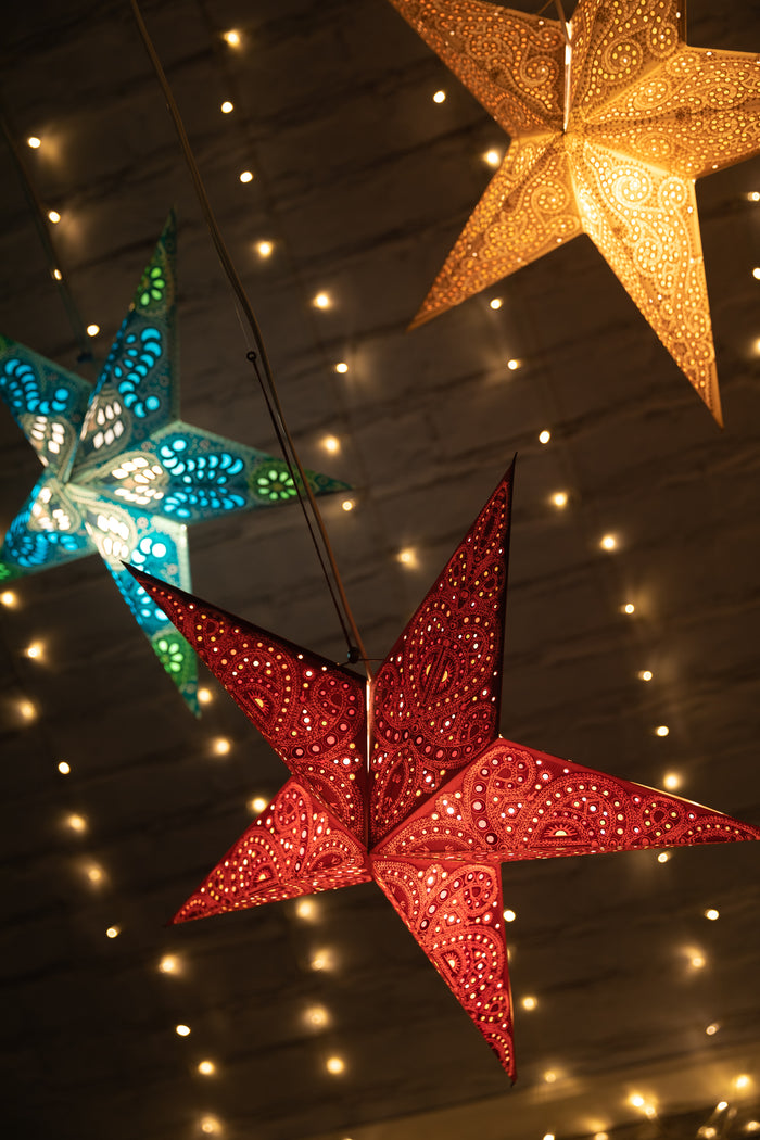 Paper star lanterns in hella - silver copper glitter, maroon, and ganesh - turquoise glitter. Light kit sold separately.