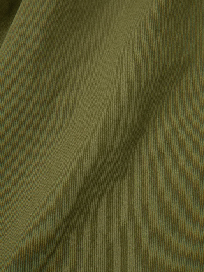 A close up image of Found Parachute Cargo Twill Pants in an olive green fabric.
