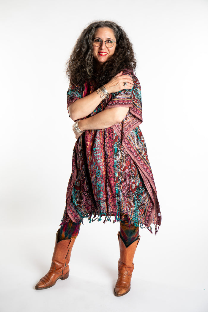 Susan is wearing the assorted one size Pari Poncho