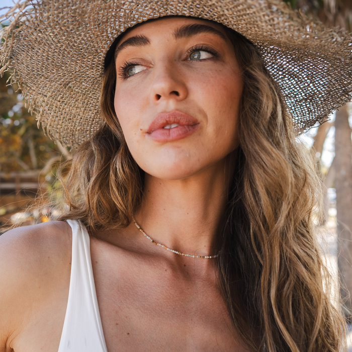 Peacemaker 2mm Healing Necklace, worn with sun hat