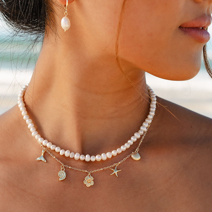 Ocean Treasures Metal Charm Necklace, worn at the beach