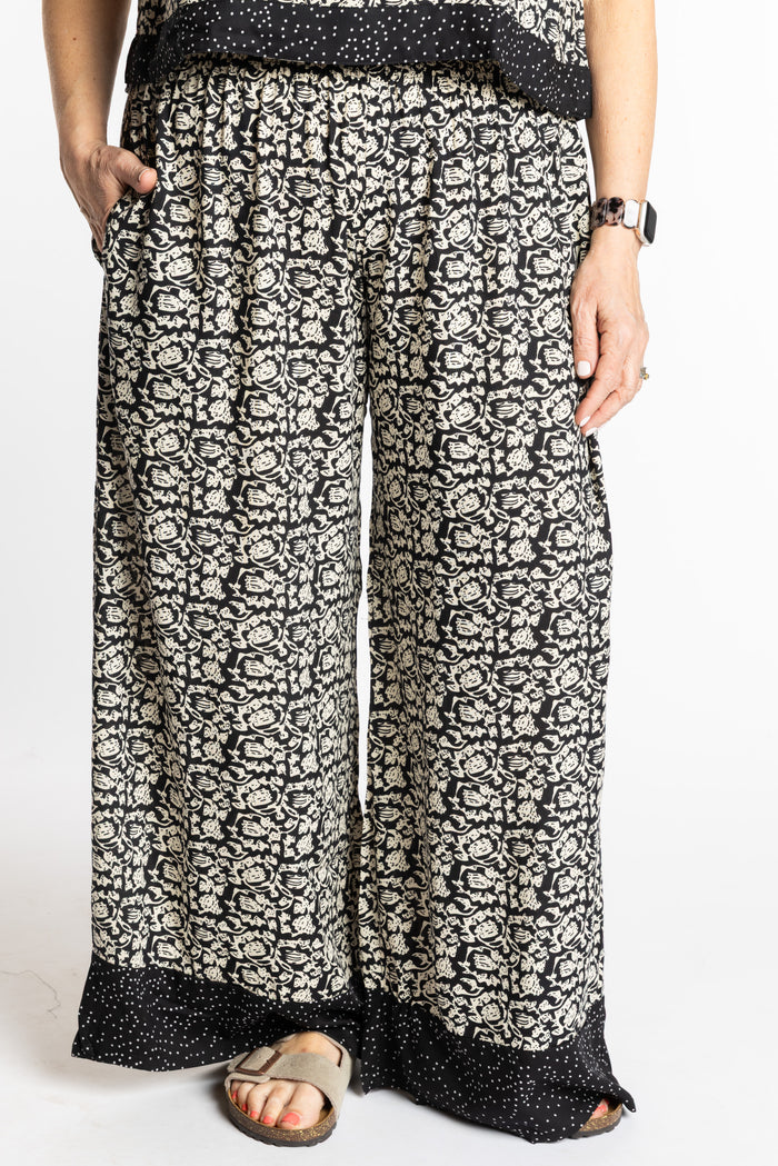 Betty wearing size M/L Black Primrose floral Penny Lane contrast hem wide leg pants
