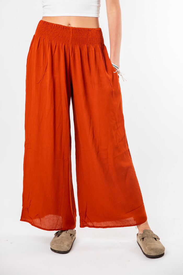 Ember is wearing size S/M wide leg pants in rust
