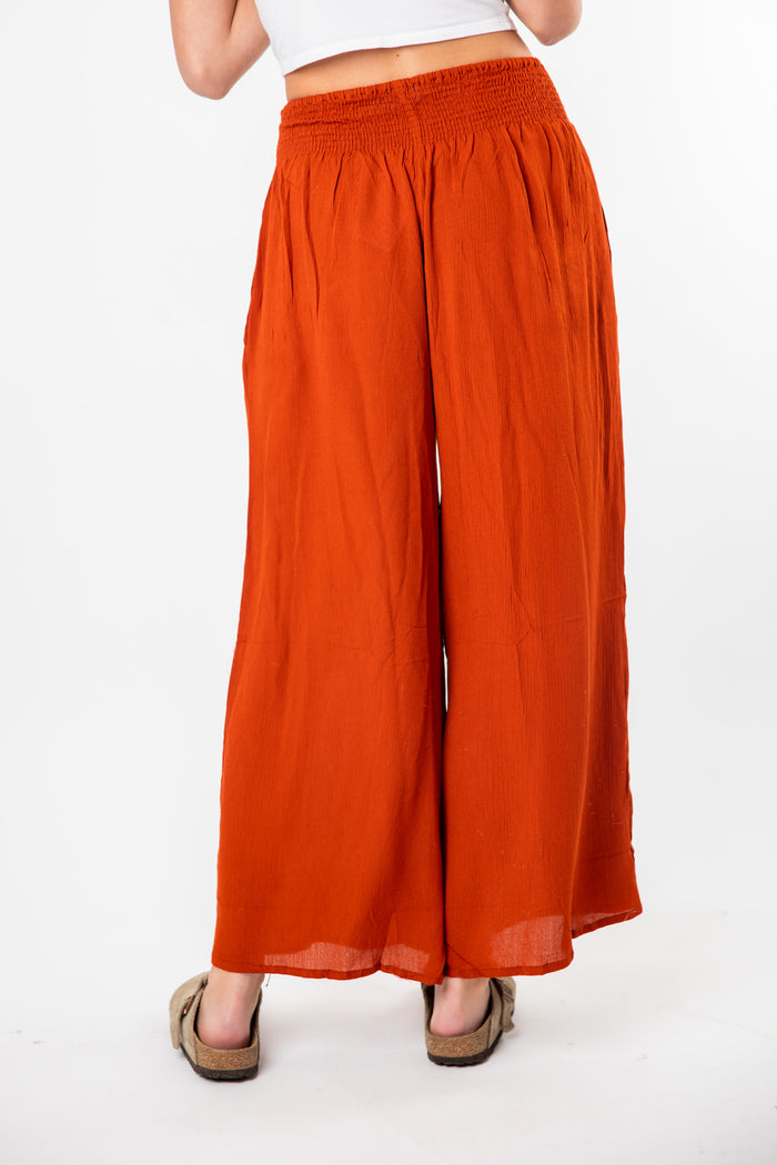 Ember is wearing size S/M wide leg pants in rust