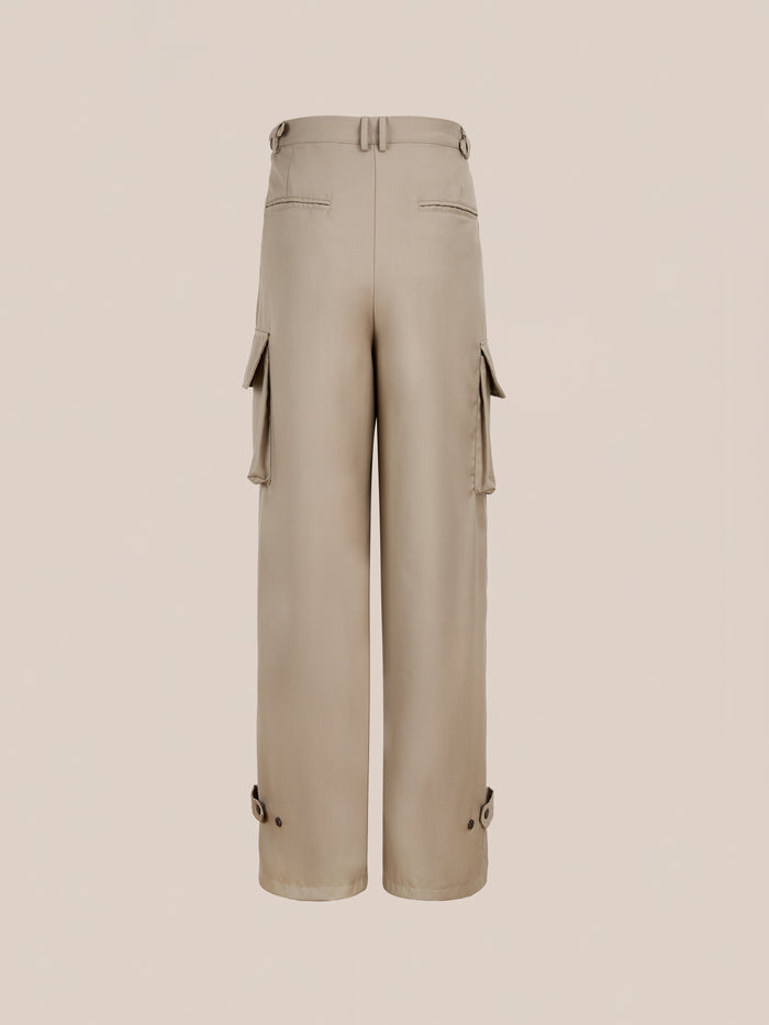 FOUND Pleated Cargo Pants in beige, featuring a relaxed fit, wide legs, side and back pockets, belt loops, lower leg button details—shown against a plain background.