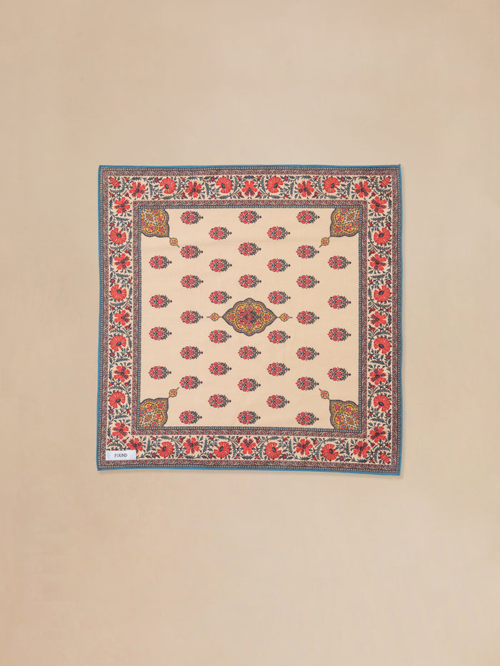 A beige and red Poinciana Bandana rug with an Indo-Aryan floral pattern by Found.