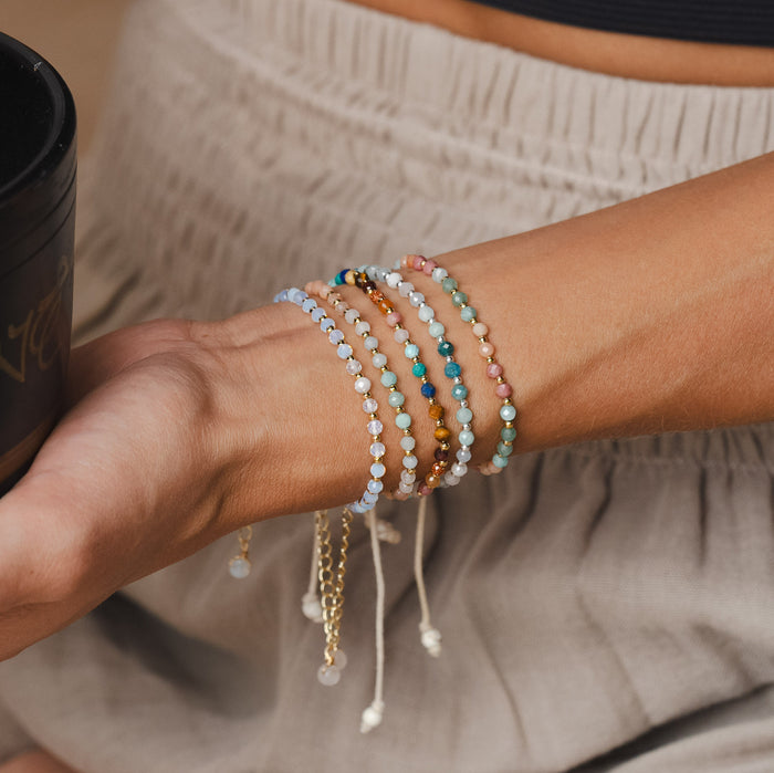 Positive Energy 3mm Healing Bracelet, stacked holding cup