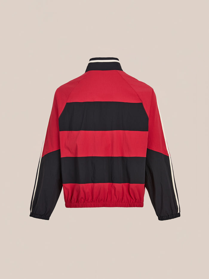 The FOUND Racing Striped Windbreaker is a vintage-inspired red and black jacket with long sleeves, elastic cuffs, and a stand-up collar, shown from the back against a plain background.