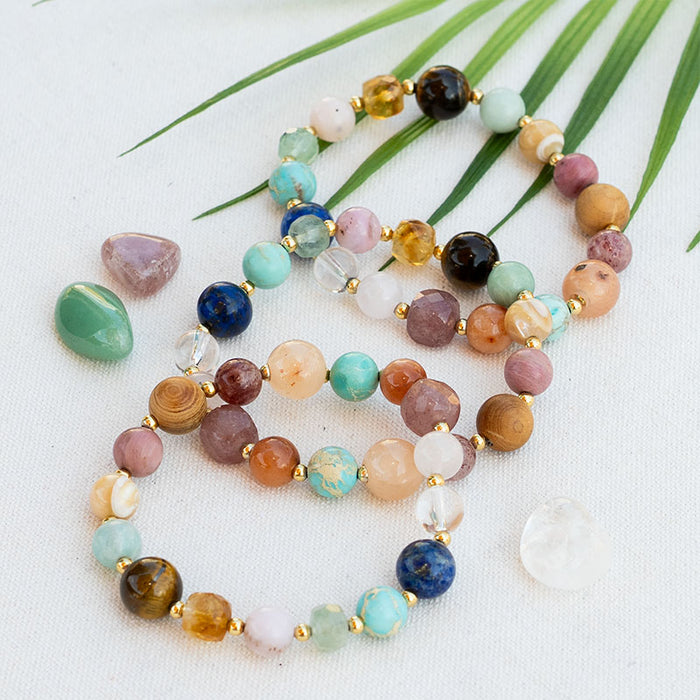 Renew Statement Healing Bracelet, flat lay with palm leaf