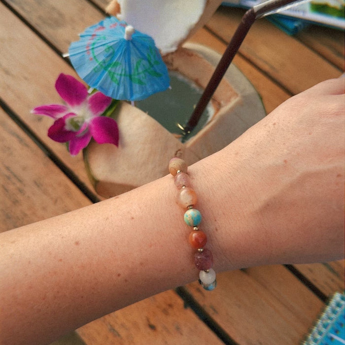 Renew Statement Healing Bracelet, on wrist with drink