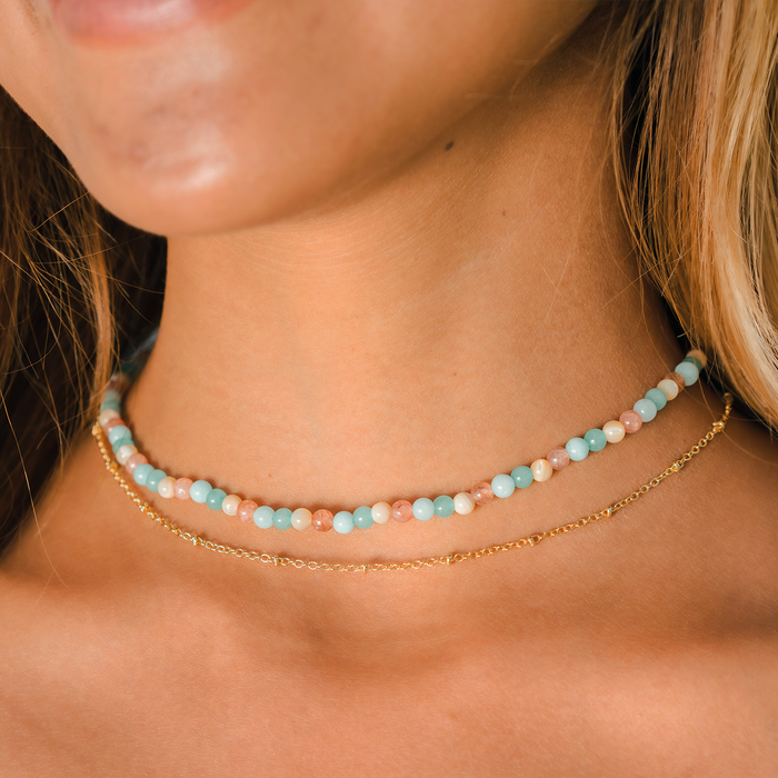 Ring of Fire Gold Necklace, on neck with beaded strand