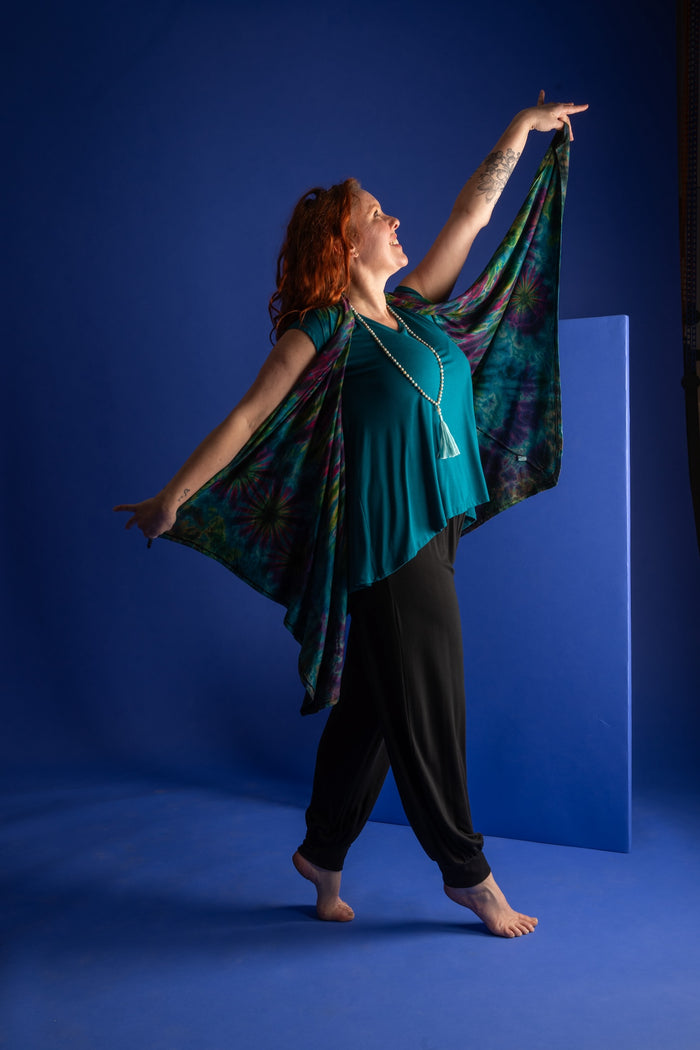 Maggie is wearing a wrap vest in teal