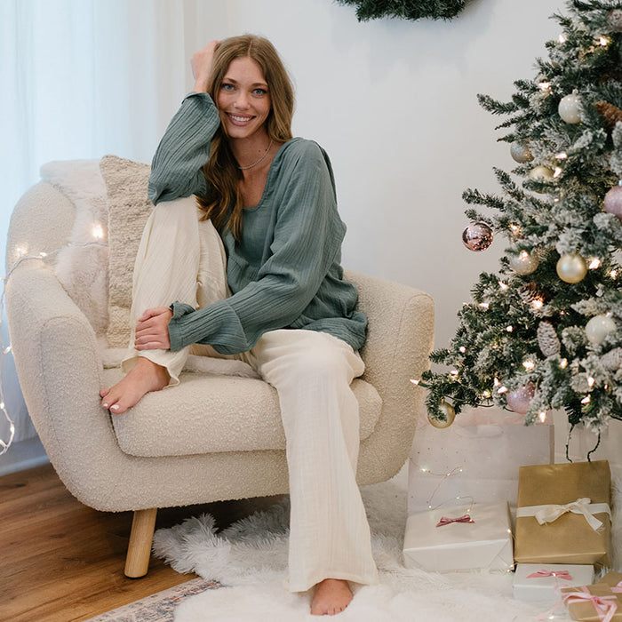 Sage Baja Pullover, worn seated by christmas tree