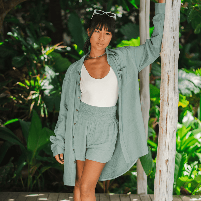 Sage Boyfriend Button Up, worn leaning on post