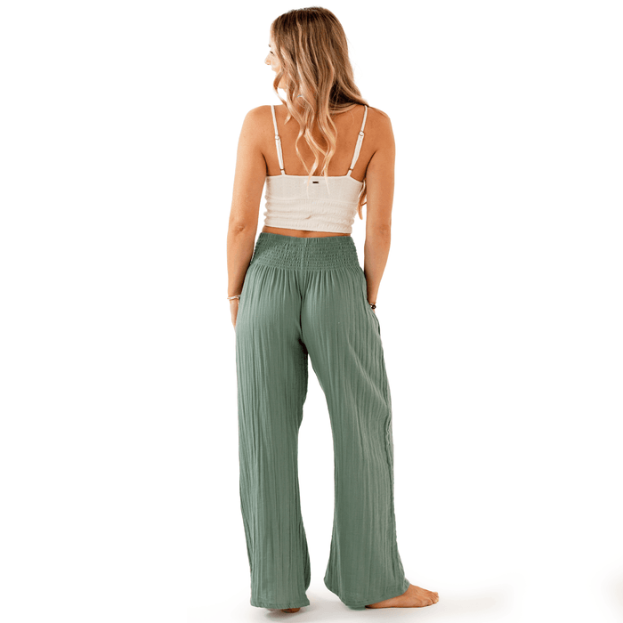 Model wearing sage wide leg cotton pants