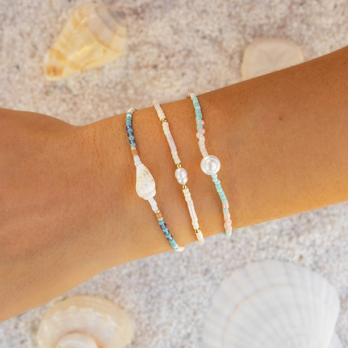 Salty Serenade Seedbead Bracelet, on wrist in the sand