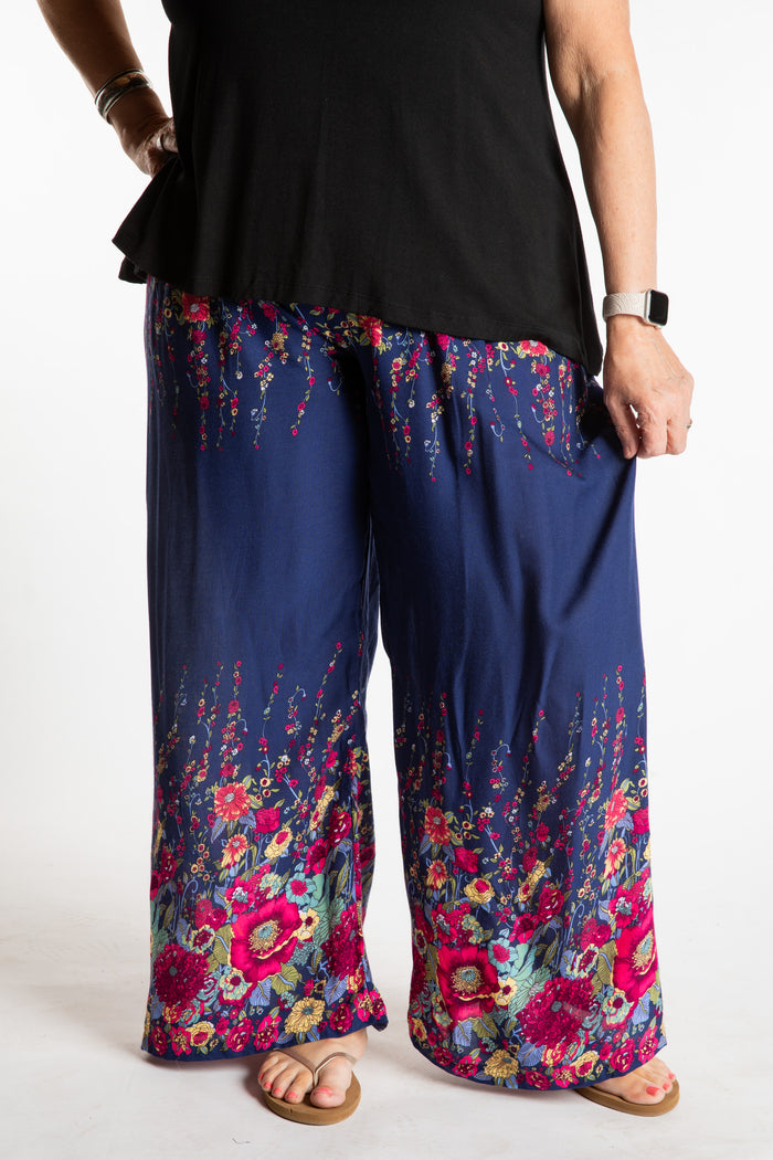 Betty is wearing floral palazzo pants in navy
