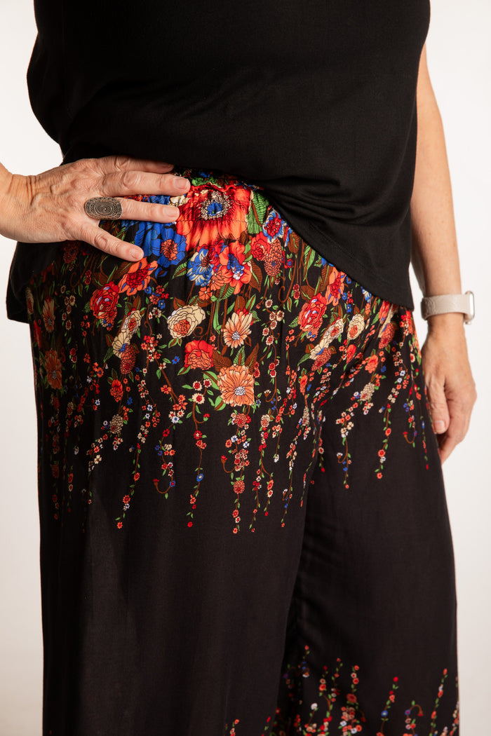 Betty is wearing floral palazzo pants in black