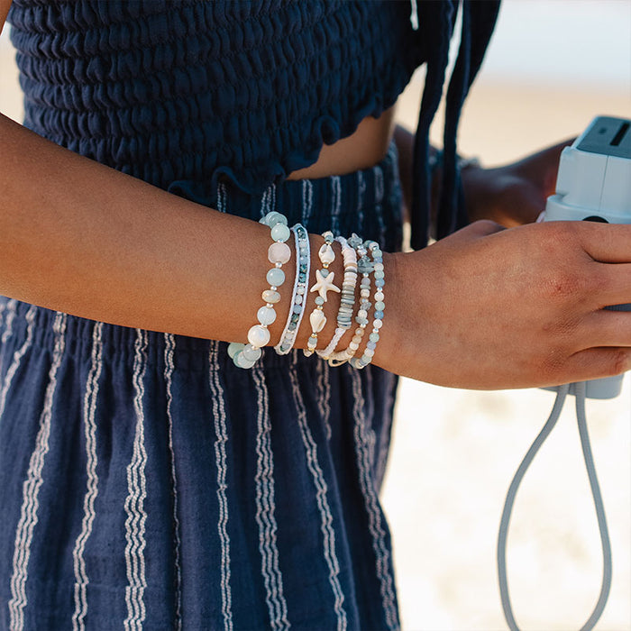 Sapphire Surf Healing Bracelet, stacked on wrist with camera