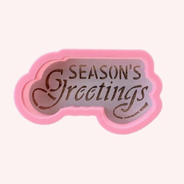 Scrolly Seasons Greetings Cookie Stencil and Cutter, a 2-piece set for decorating holiday cookies.