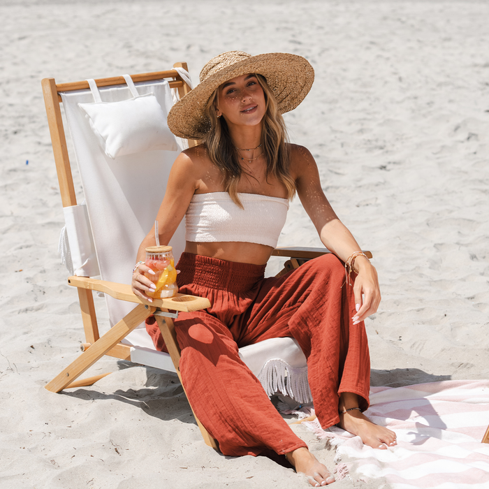 Seaside Spice Wide Leg Cotton Pants, worn seated on the beach