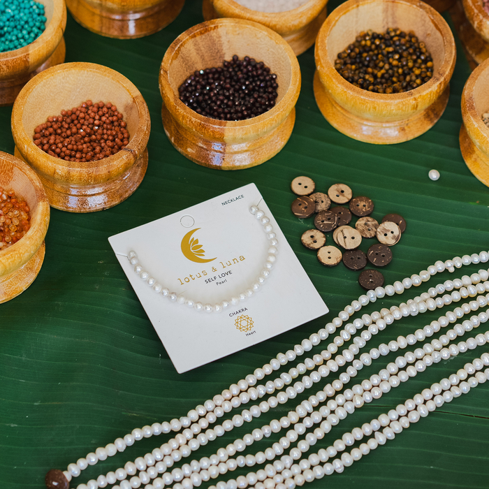 Self Love 4mm Healing Bracelet, flat lay with bead bowls