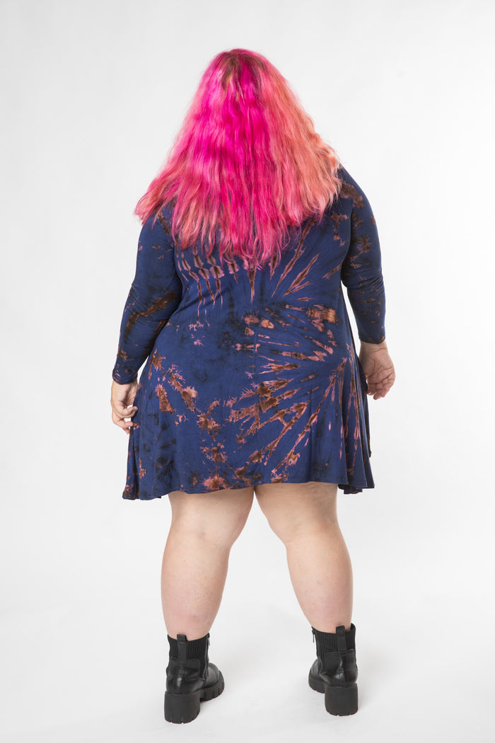 Angel is wearing a long sleeve tie dye dress in navy