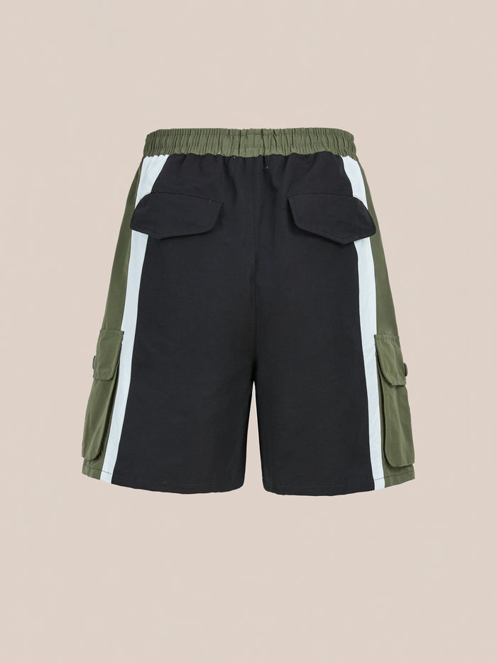 Back view of Found Sporting Club Track Shorts, unisex athletic shorts in black and olive green with white side stripes, elastic waistband, flap back pockets, and cargo pockets inspired by vintage styles.