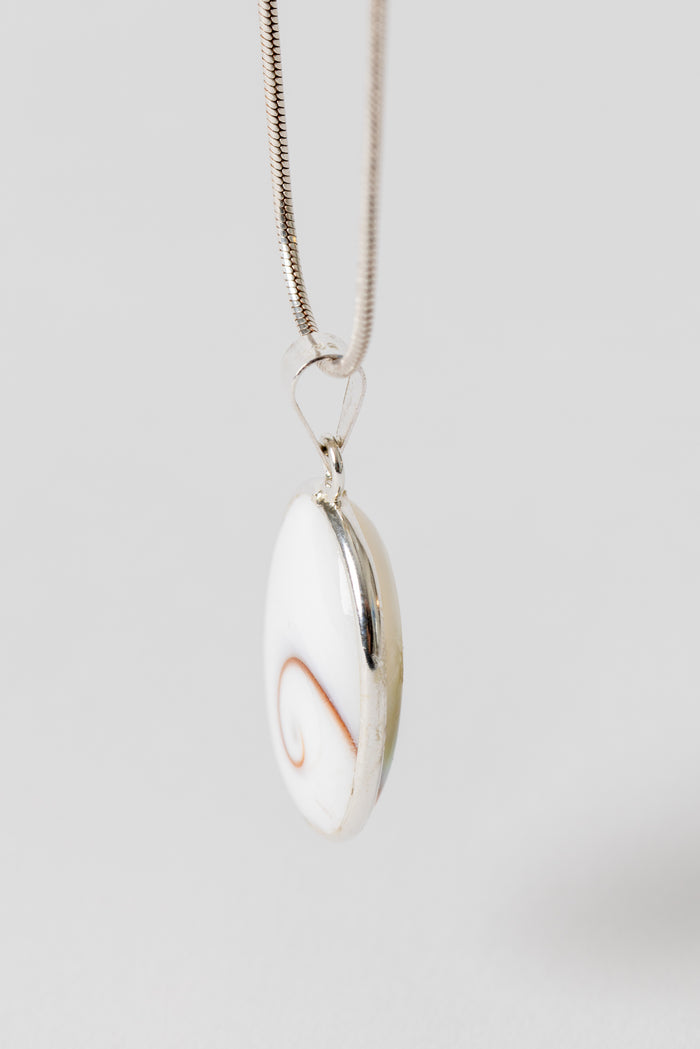 Sterling Shiva eye pendant with natural shell spiral pattern