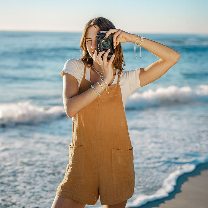 Sunflower Boardwalk Romper, worn on the beach