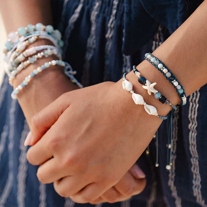 Swell Braided Shell Bracelet, on wrist with hands clasped