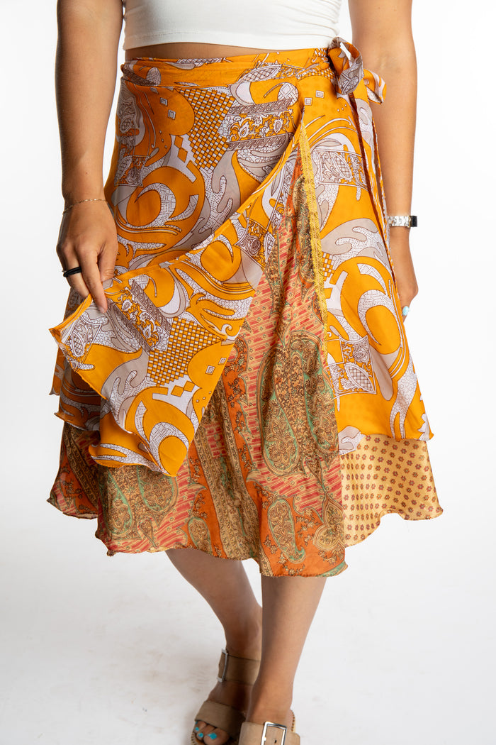 Sophie is wearing a midi reversible silk wrap skirt in fire on the mountain