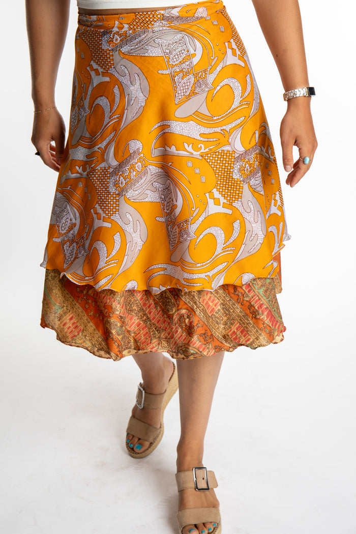 Sophie is wearing a midi reversible silk wrap skirt in fire on the mountain