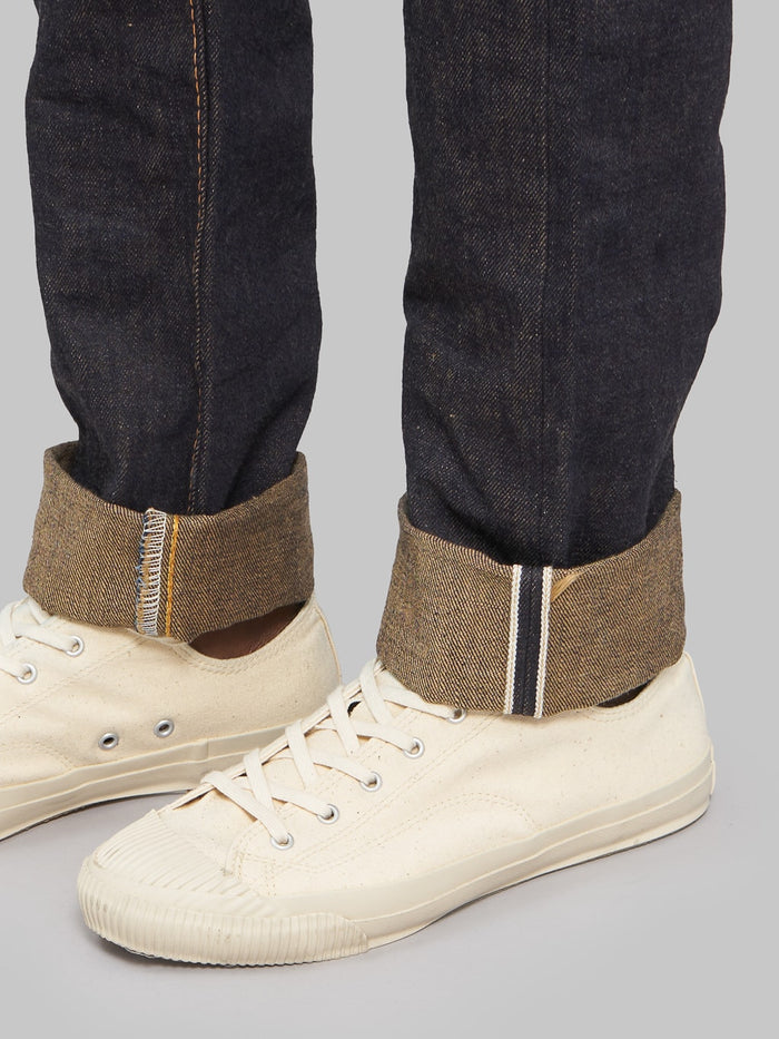 The Strike Gold Brown Weft Slim Tapered Jeans gold selvedge line