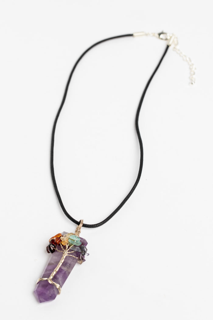 tree of life crystal necklace pendant in amethyst on white background