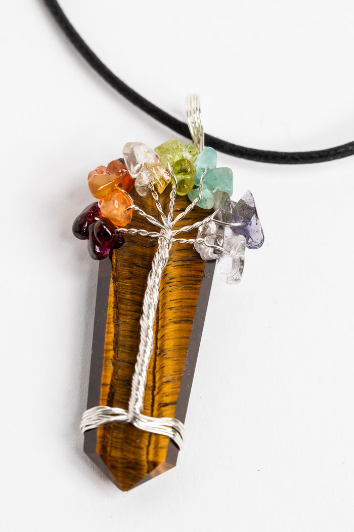 tree of life crystal necklace pendant in tiger eye on white background
