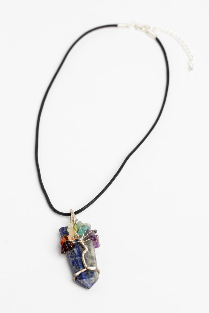 tree of life crystal necklace pendant in lapis on white background