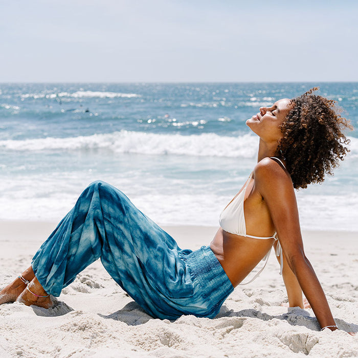 Turquoise Tide Harem Pants, reclining on the sand