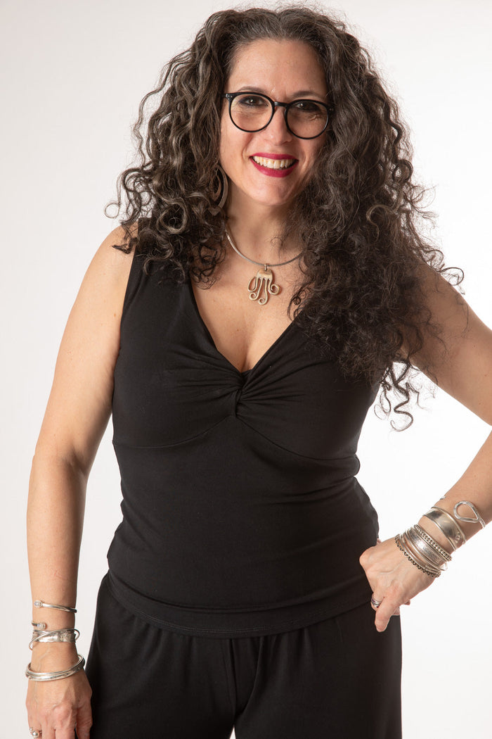 Susan is wearing the Twist Front Tank in Black in M/L