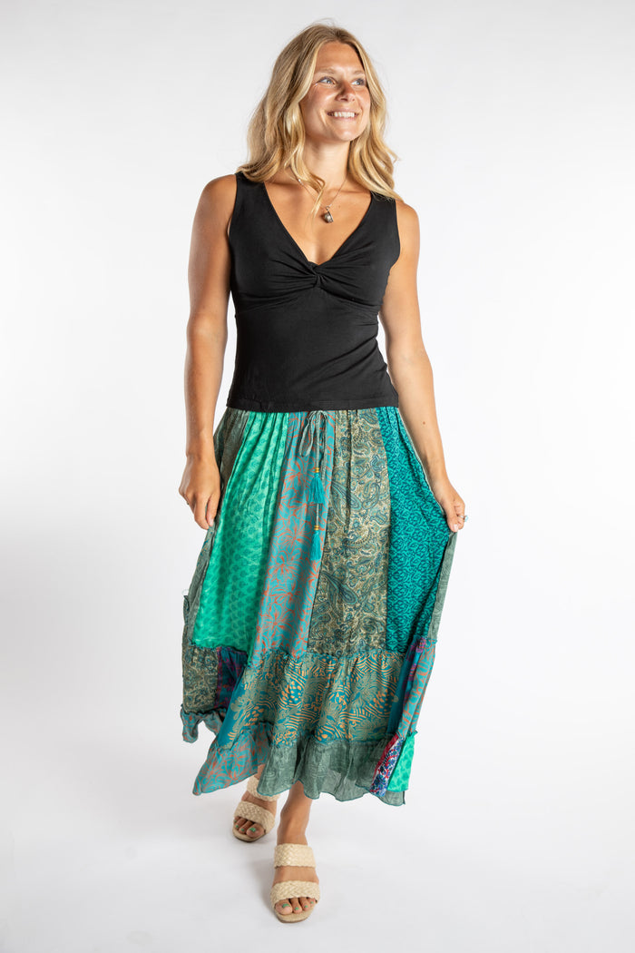 Sophie is wearing size S/M Women's Tank Top in Black with blue patchwork skirt