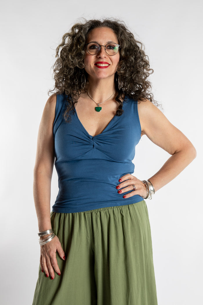Susan is wearing the Twist Front Tank in Ocean in M/L