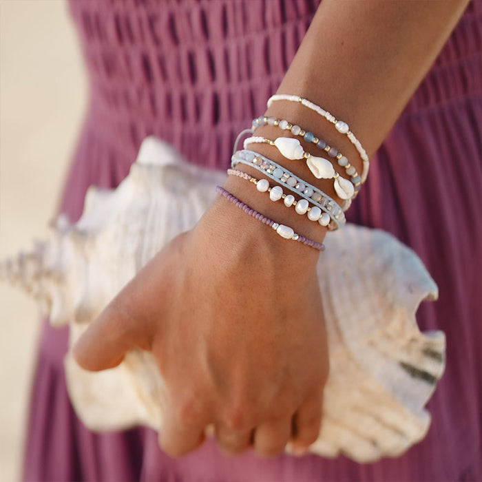 White Sand Beach Seedbead Bracelet, worn holding a shell