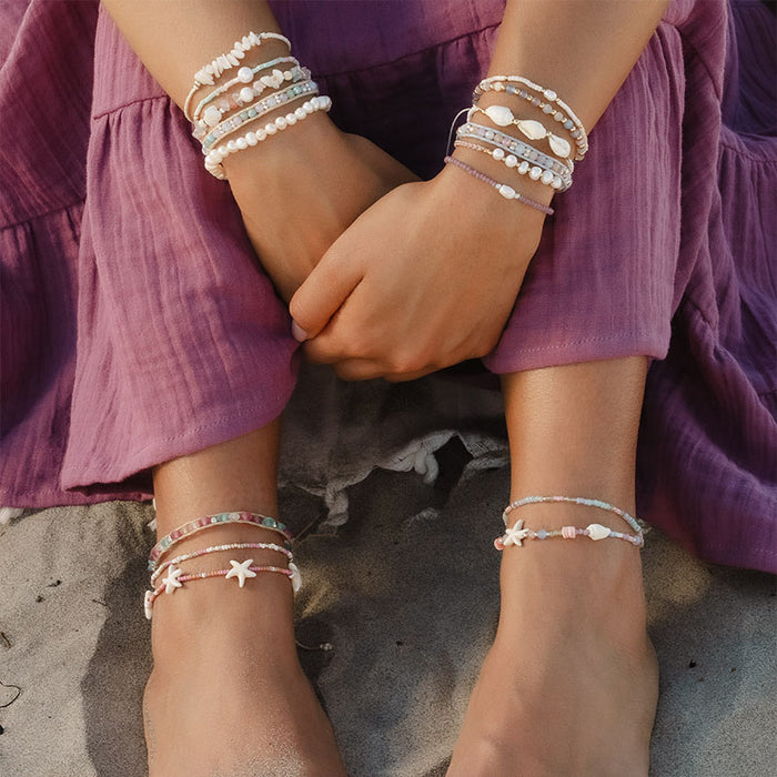 White Sand Beach Seedbead Bracelet, worn seated
