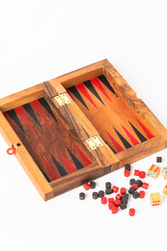 Open handcrafted wooden backgammon and checkers board with pieces — dual-purpose artisan game set.