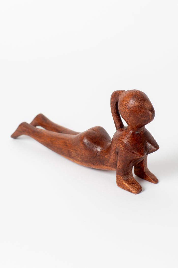 Wooden yoga sculpture in upward dog