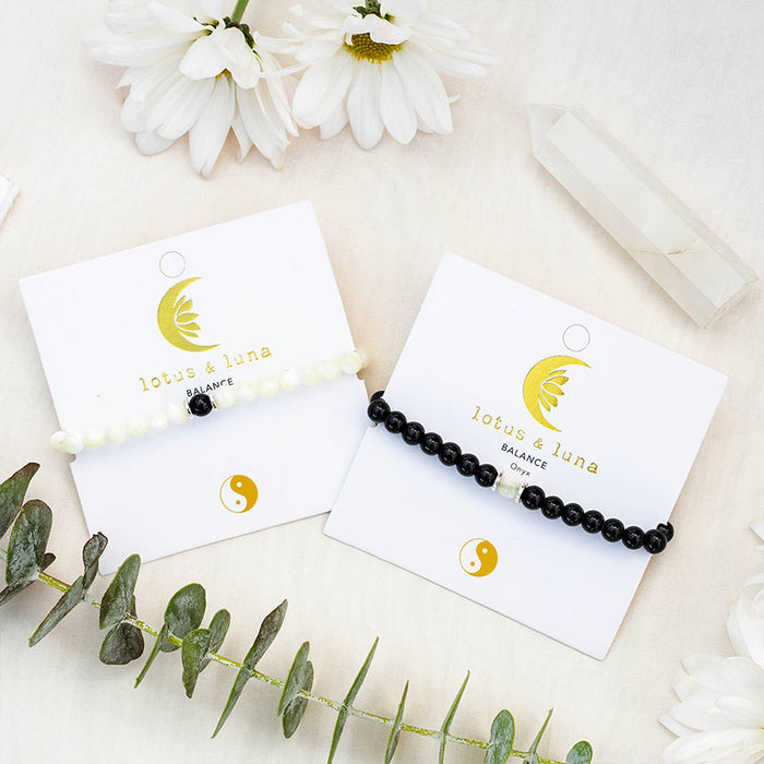 Yin to My Yang Bracelet Stack, flat lay on cards with flowers